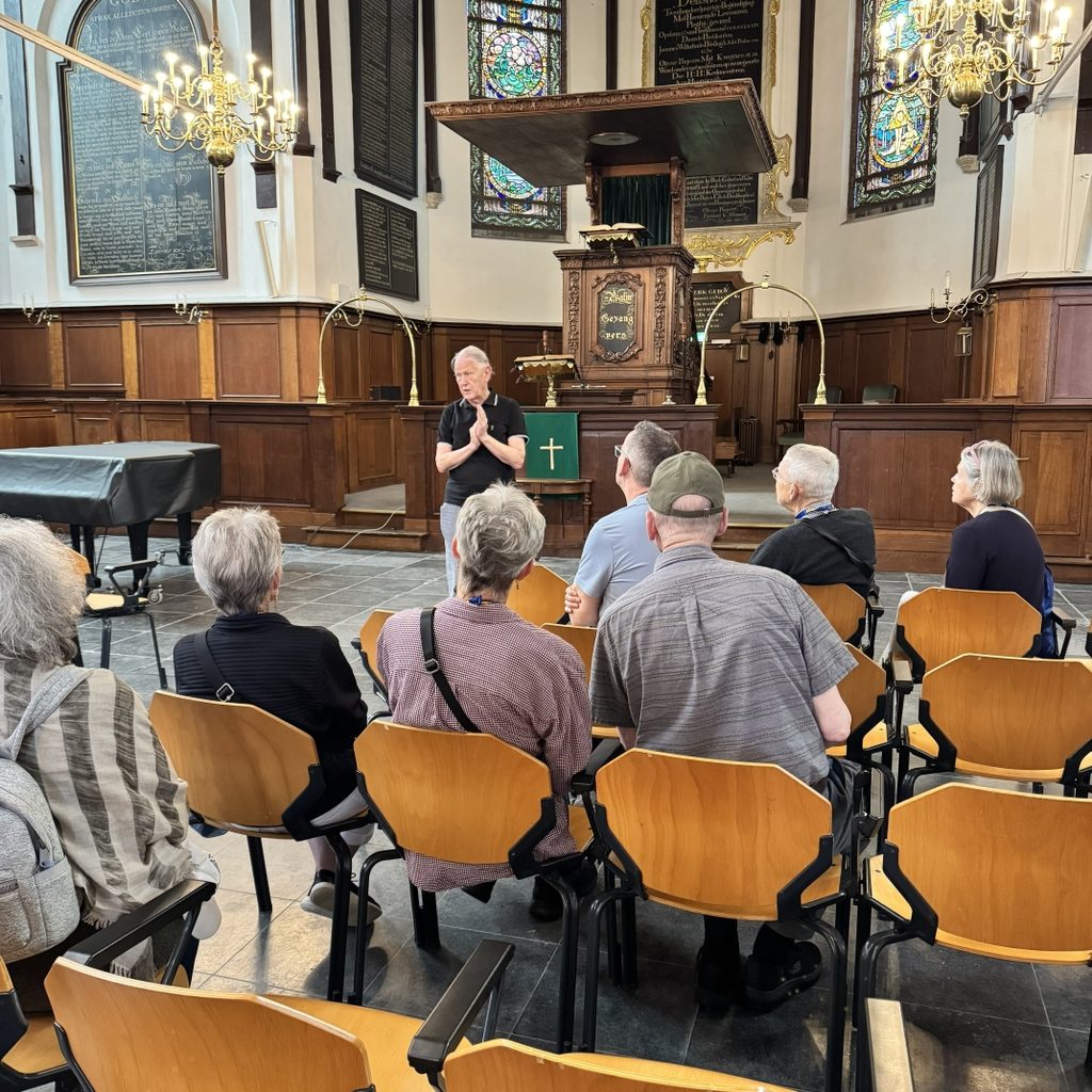 The NYG&B group listening to the guide in the Pilgrim Fathers Church in Delfshaven.