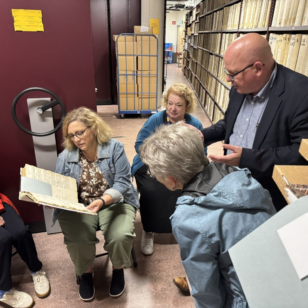 Members of the NYG&B group looking at original records in Leiden.