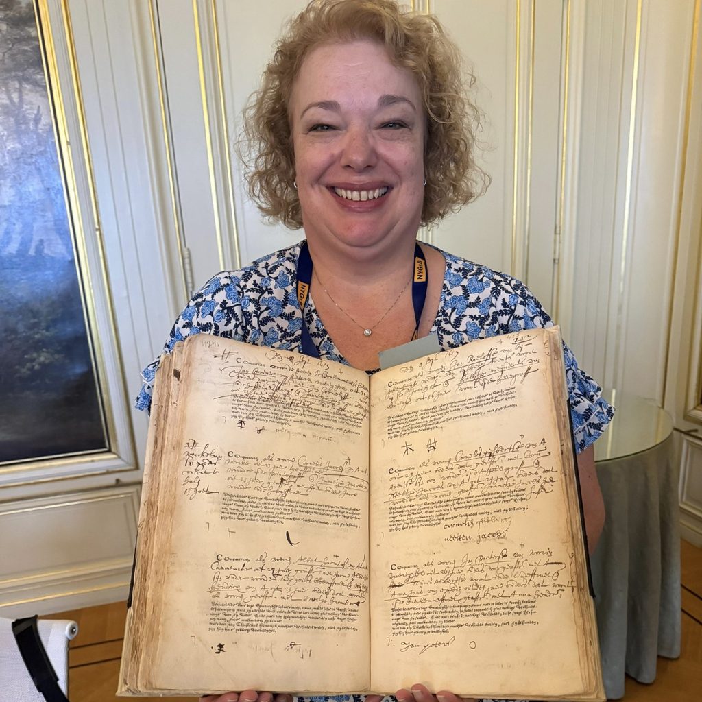 One of the NYG&B members showing an original record with her ancestor's name.